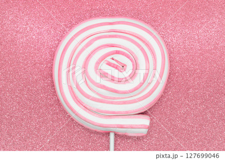 Round marshmallow lollipop on stick on shiny pink background 127699046