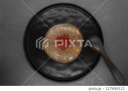 Composition of Saffron in natural coconut brown bowl and black wooden rural spoon 127699121