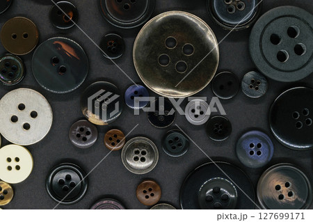 Various dark clothes buttons background 127699171