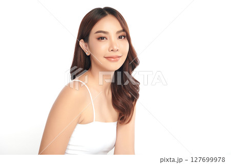 A beautiful young Asian woman with clean, fresh skin against a white background. Skincare, facial treatment, cosmetology, beauty, and spa. An elegant portrait of an Asian woman. 127699978