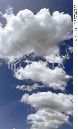 Clear blue sky with soft white clouds, perfect for nature, weather, and tranquility themes Clear blue sky with soft white clouds, perfect for nature, weather, and tranquility themes 127700333
