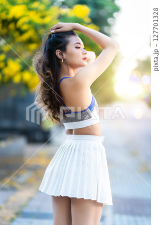 Portrait of beautiful athletic young asian woman in fashionable sportswear standing and having rest after strong exercise training in garden the park,Outdoor Sporty concept Portrait of beautiful athletic young asian woman in fashionable sportswear standing and having rest after strong exercise training in garden the park,Outdoor Sporty concept 127701328