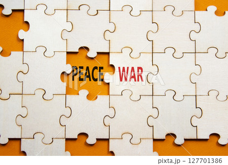 War or Peace symbol. Concept word War or Peace on wooden puzzle. Beautiful orange background. Business and War or Peace concept. Copy space 127701386
