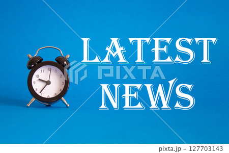 Latest News symbol. Concept word Latest News on Beautiful blue background with alarm clock. Business and Latest News concept. Copy space Latest News symbol. Concept word Latest News on Beautiful blue background with alarm clock. Business and Latest News concept. Copy space 127703143