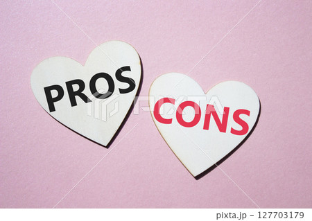 Pros vs Cons symbol. Concept word Pros vs Cons on wooden hearts. Beautiful pink background. Business and Pros vs Cons concept. Copy space 127703179