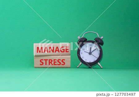 Manage stress symbol. Concept word Manage stress on wooden blocks. Beautiful green background with alarm clock. Business and Manage stress concept. Copy space Manage stress symbol. Concept word Manage stress on wooden blocks. Beautiful green background with alarm clock. Business and Manage stress concept. Copy space 127703497
