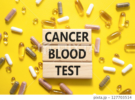 Cancer Blood Test symbol. Concept word Cancer Blood Test on wooden blocks. Beautiful yellow background with pills. Medicine and Cancer Blood Test concept. Copy space 127703514