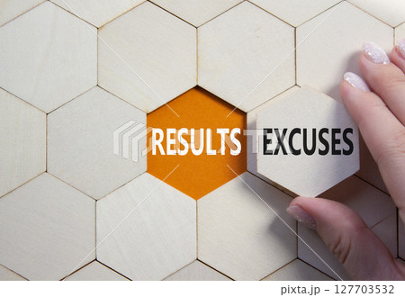 Results or Excuses symbol. Concept word Results or Excuses on wooden comb puzzle. Businessman hand. Beautiful orange background. Business and Results or Excuses concept. Copy space 127703532