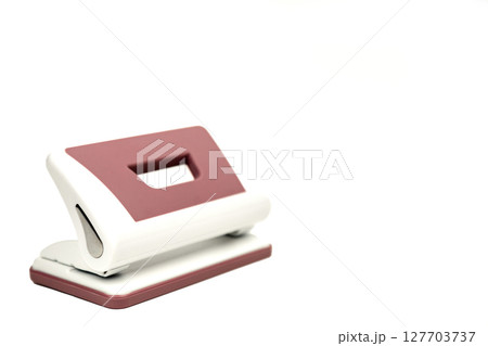 A device for piercing holes in paper. Office accessory on a white background 127703737