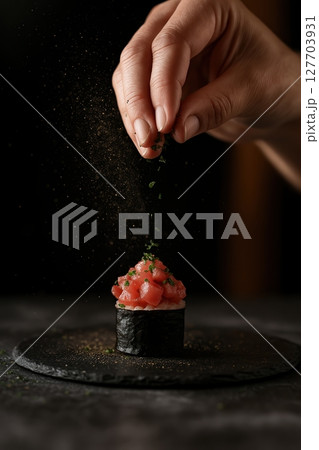 Tuna gunkan sushi garnished with herbs 127703931