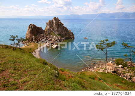 Cape Burhan, Shamanka or Shaman Rock in summer day. Lake Baikal, Olkhon Island. Cape Burhan, Shamanka or Shaman Rock in summer day. Lake Baikal, Olkhon Island. 127704024