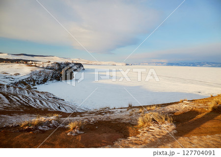 Lake Baikal in winter. View of a frozen lake covered with snow. 127704091
