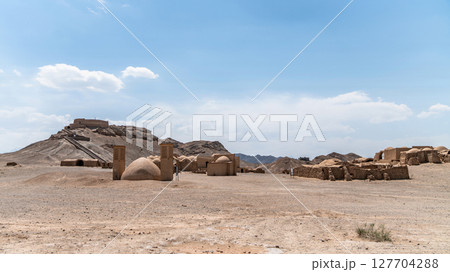 The ancient Zoroastrian Towers of Silence in Yazd, elevated circular structures on arid hills, under a vast sky 127704288