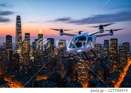 Futuristic autonomous air taxi flying over modern city at sunset, this concept is for future urban mobility and smart transport 127704474