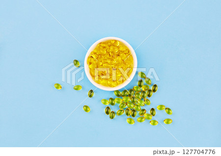 Yellow capsules with Vitamin D3. Healthy and medical concept, sunshine vitamin. 127704776