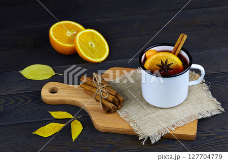 Hot red autumn mulled wine in white rustic mug with spices and citrus fruits Hot red autumn mulled wine in white rustic mug with spices and citrus fruits 127704779