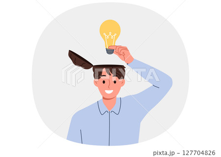 Man learns about innovative idea puts light bulb inside head to improve own creative thinking Man learns about innovative idea puts light bulb inside head to improve own creative thinking 127704826