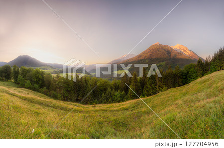 Meadow with road and bench during sunset in Berchtesgaden National Park Meadow with road and bench during sunset in Berchtesgaden National Park 127704956