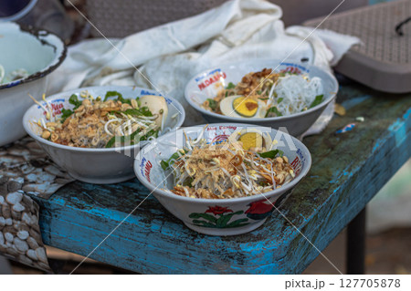 Savory Soto Ayam Dish with Various Toppings at Mataram, Lombok, Indonesia - September 1, 2024 127705878