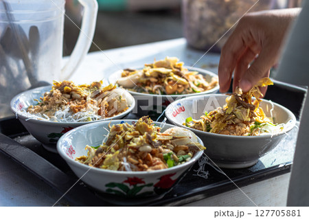 Savory Soto Ayam Dish with Various Toppings at Mataram, Lombok, Indonesia - September 1, 2024 127705881
