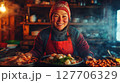 Cooking traditional meals in a cozy kitchen with warm lighting and a joyful chef preparing delicious dishes 127706329