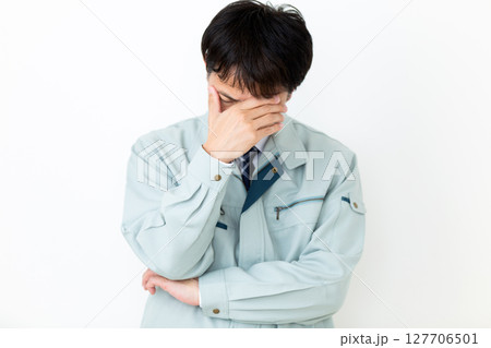 グリーンの作業服を着て悩むミドル男性ビジネスマン グリーンの作業服を着て悩むミドル男性ビジネスマン 127706501