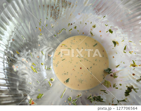 Salad juice leftovers in a glass bowl 127706564