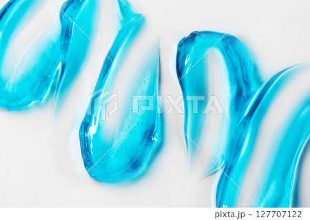 Smears of blue cosmetic gel on a white background Smears of blue cosmetic gel on a white background 127707122