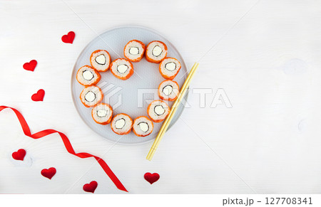 Heart shaped of sushi rolls for Valentine's Day. Flat lay, with space for text. Heart shaped of sushi rolls for Valentine's Day. Flat lay, with space for text. 127708341