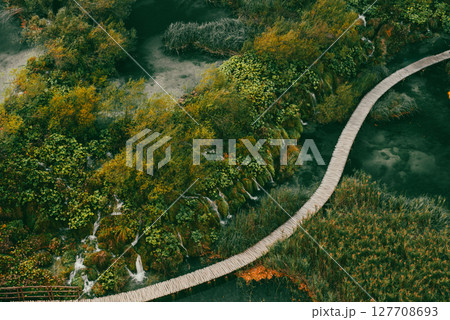 Aerial top down view of a wooden walkway in Plitvice Lakes National Park with small waterfalls 127708693