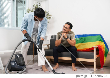 LGBTQIA Pride and Home Cleaning. Friends working together to tidy up a vibrant living space. 127708798