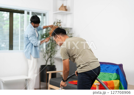 Home Cleaning and Bonding. Two friends working together to tidy their living space with joy. Home Cleaning and Bonding. Two friends working together to tidy their living space with joy. 127708906