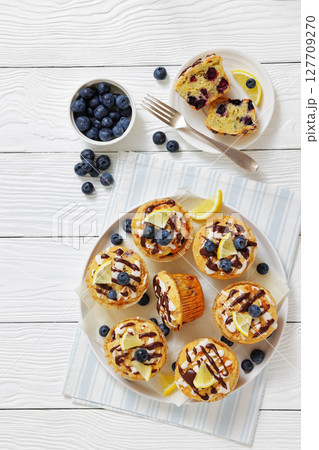tasty blueberry muffins with lemon chocolate glaze 127709270