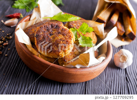 fried cutlets on brown bowl fried cutlets on brown bowl 127709295