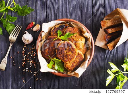 fried cutlets on brown bowl fried cutlets on brown bowl 127709297