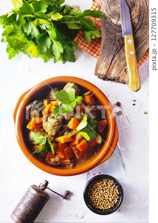 Fried chicken liver with onions and carrots 127709315