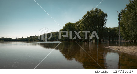 The image showcases the calm water meeting lush, green shores The image showcases the calm water meeting lush, green shores 127710317