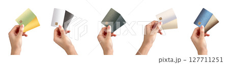Bank card in hand, holding two different cards for choice in payment. Offering options for debit or Bank card in hand, holding two different cards for choice in payment. Offering options for debit or 127711251