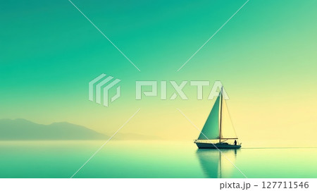 Sailboat gliding across calm waters near distant mountains during a serene dawn 127711546