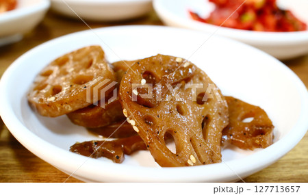 Glazed lotus root slices in sweet soy sauce Korean banchan side dish with traditional holes pattern and caramelized finish 127713657