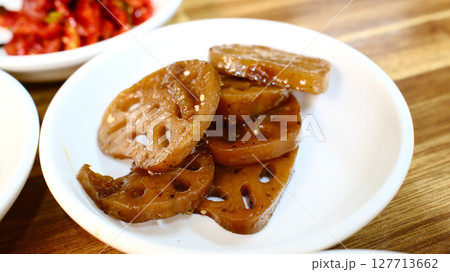 Glazed lotus root slices in sweet soy sauce Korean banchan side dish with traditional holes pattern and caramelized finish 127713662