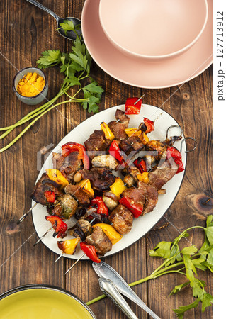 Meat skewers or kebabs, barbecued. 127713912