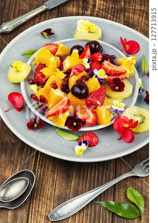 Fruit salad decorated with flowers. Fruit salad decorated with flowers. 127713915
