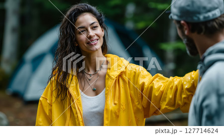 A man and a woman standing in front of a tent in the woods A man and a woman standing in front of a tent in the woods 127714624