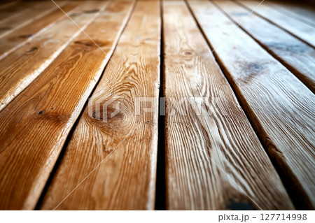 A close up view of a wooden floor with a light shining through it 127714998