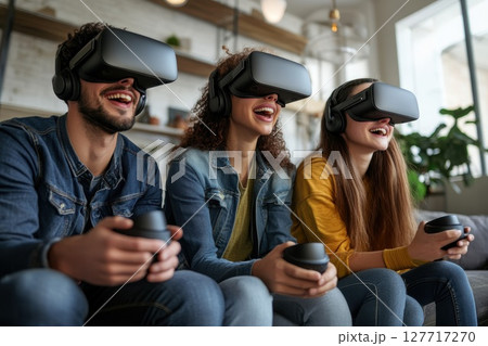 Group of friends enjoy virtual reality gaming experience indoors at home during a relaxed afternoon gathering 127717270