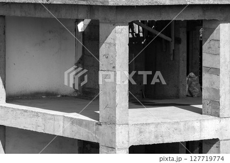 A grayscale photograph showing an incomplete concrete building A grayscale photograph showing an incomplete concrete building 127719774
