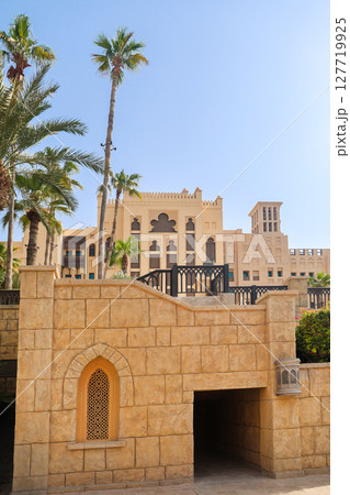 Architecture of the old district of Dubai in oriental style, near the water canal 127719925