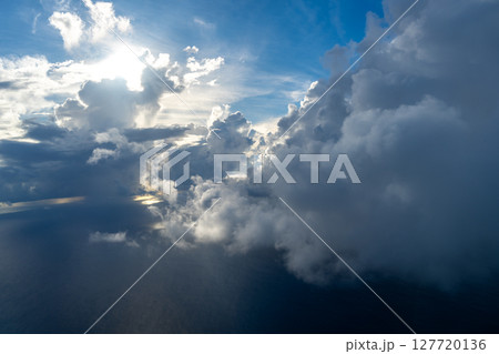 Dramatic sky with sunbeams and clouds seen from an airplane 127720136
