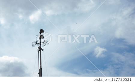 Surveillance equipment stands tall against a cloudy sky, focusing on communication efforts in a war zone, critical for military operations and intelligence gathering. Surveillance equipment stands tall against a cloudy sky, focusing on communication efforts in a war zone, critical for military operations and intelligence gathering. 127720521